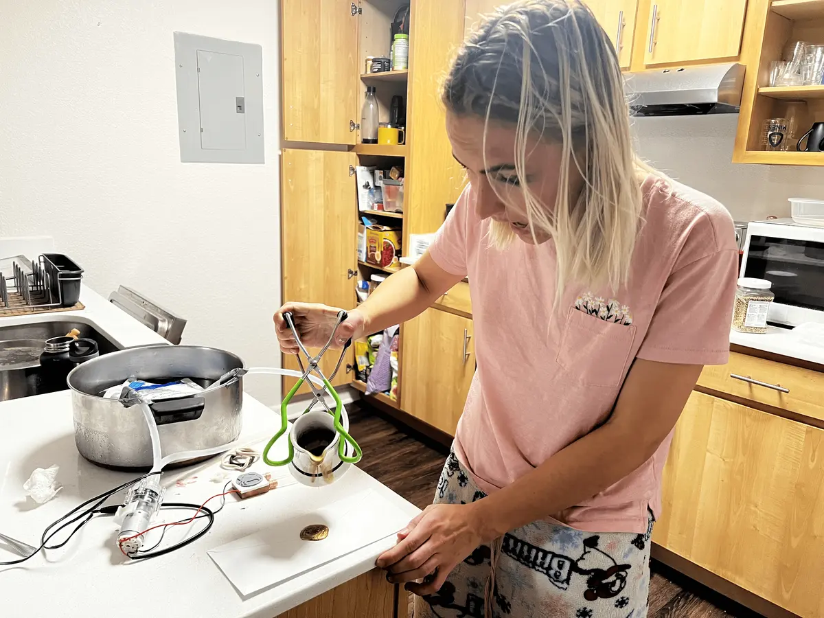 Hand applying a custom wax seal to an envelope